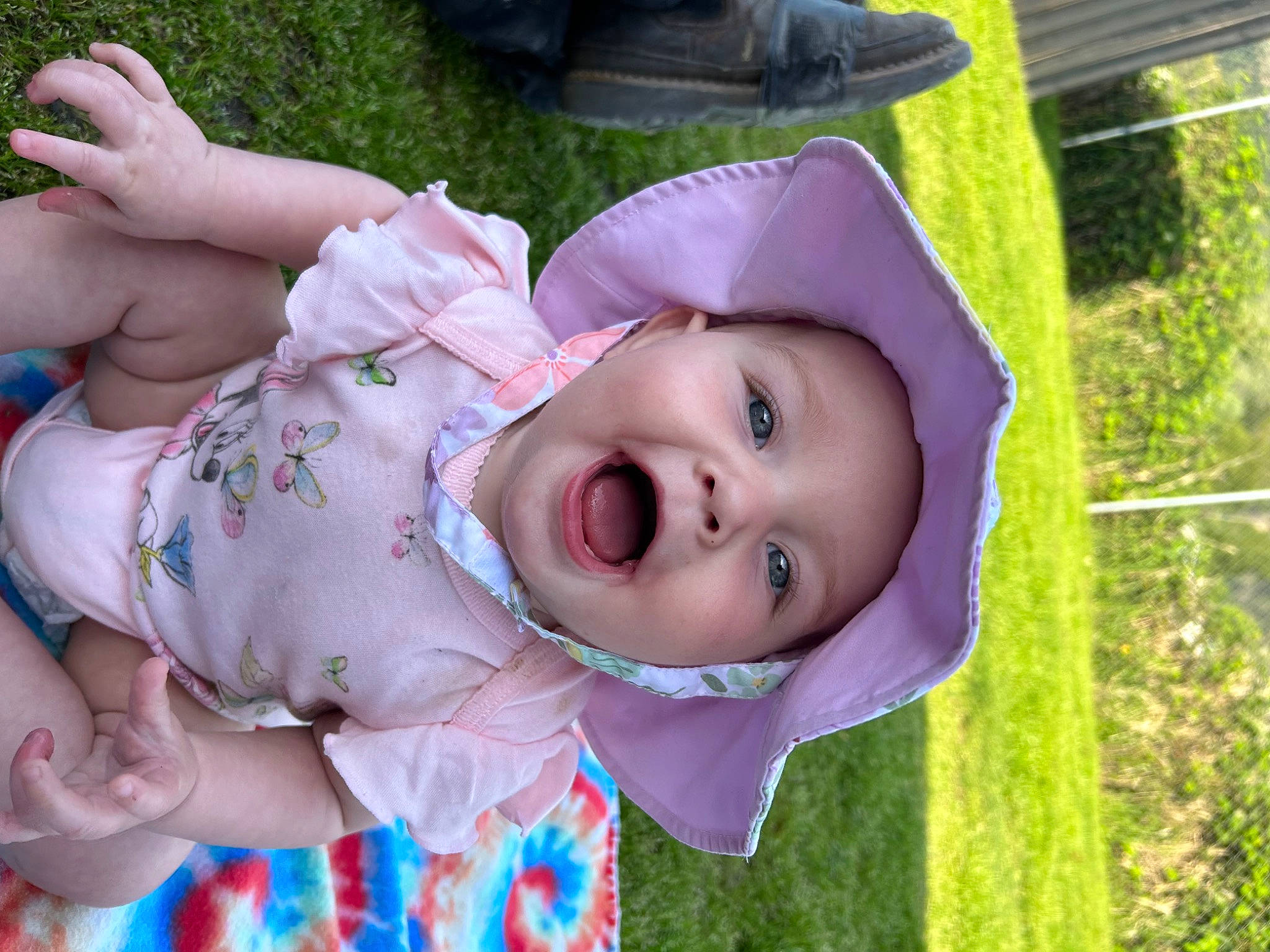 Emilie joined the competition — help win amazing prizes! baby, baby_products, baby_toddler_clothing, cheek, child, face, fun, grass, green, happy, hat, headwear, leisure, person, pink, plant, purple, skin, smile, sun_hat