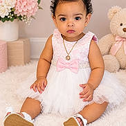 Ashley Nicole is registered to the contest to win money with this photo: baby, child, portrait, sitting, indoors, pink_dress, white_dress, bow, necklace, shoes, teddy_bear, flowers, bouquet, nursery, carpet, fluffy_rug, studio_photography, curly_hair, smiling, fashion