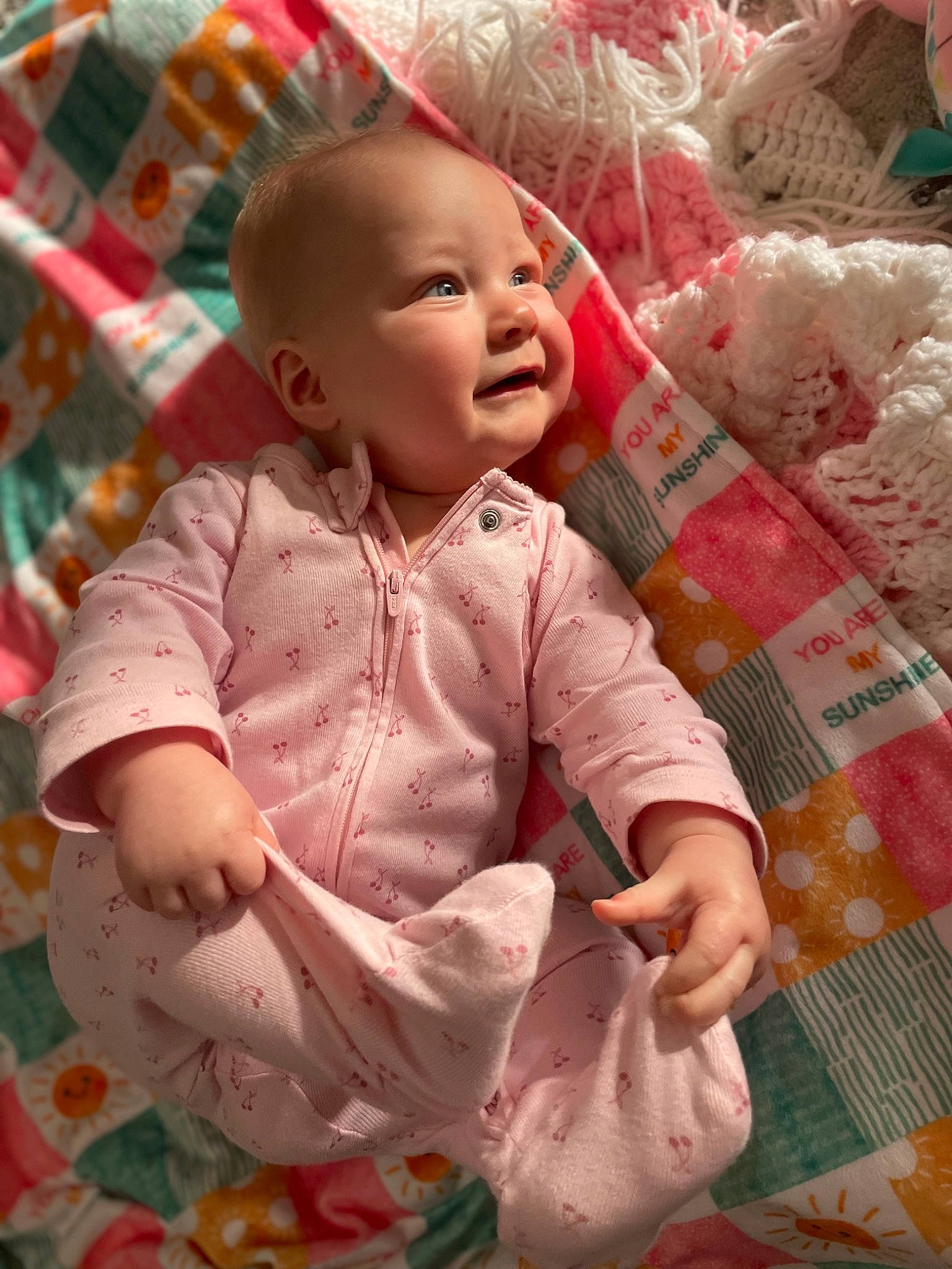 Alaina is registered to the contest to win money with this photo: baby, baby_products, baby_toddler_clothing, cheek, child, facial_expression, happy, head, linens, magenta, pattern, peach, person, pink, sitting, skin, sleeve, smile, textile, toddler