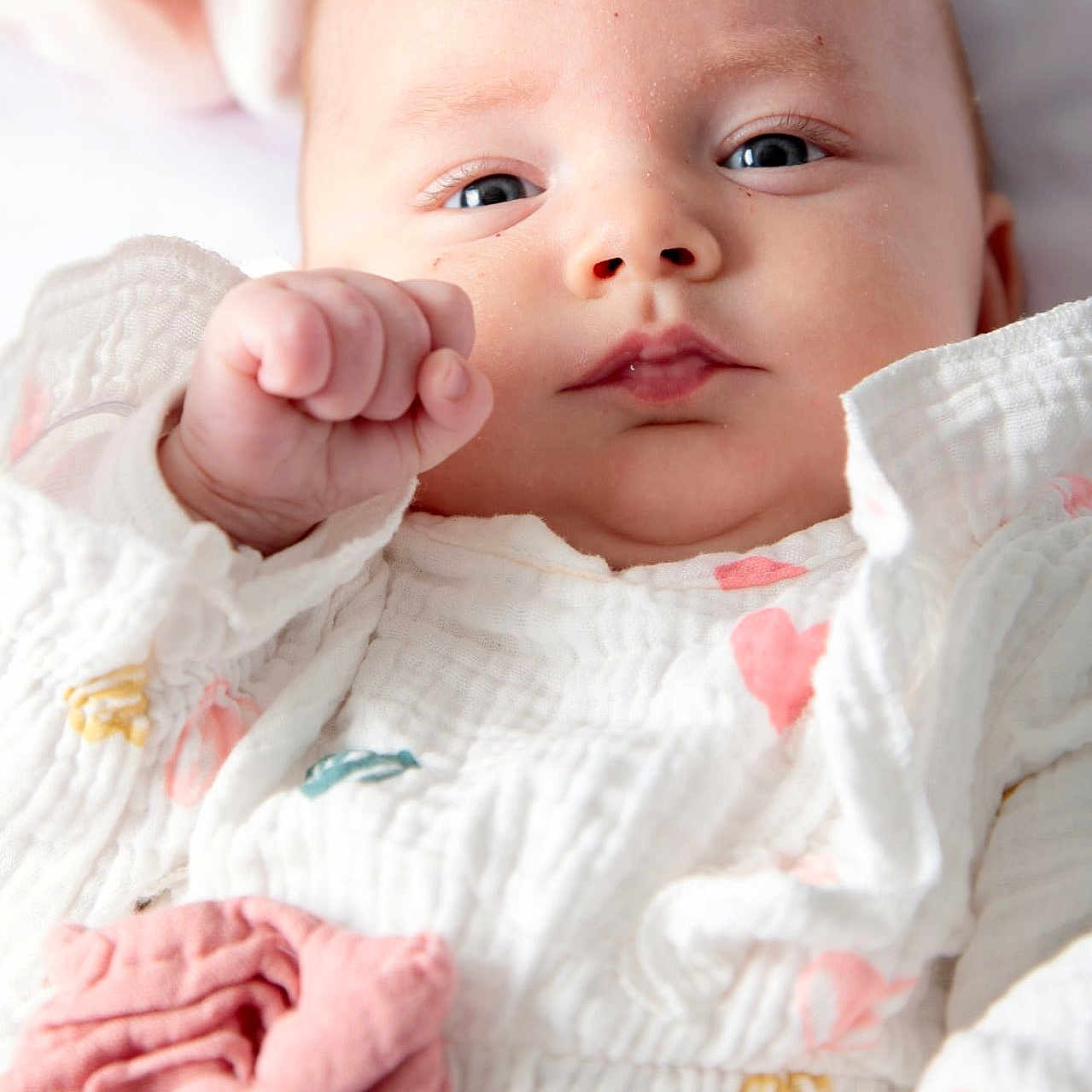 Lysaé participe au concours pour gagner de l'argent avec cette photo : baby, child, closeup, comfortable, cozy, cute, expression, eyes, fabric, face, hand, infant, lying_down, newborn, pastel_colors, pink_bow, portrait, skin, soft_texture, white_clothing