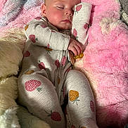 Emmaline joined the competition — help win amazing prizes! baby, sleeping, blanket, soft_texture, onesie, strawberry_pattern, infant, cozy, pink, white, yellow, child, cute, resting, comfort, indoors, portrait, peaceful, warm, face