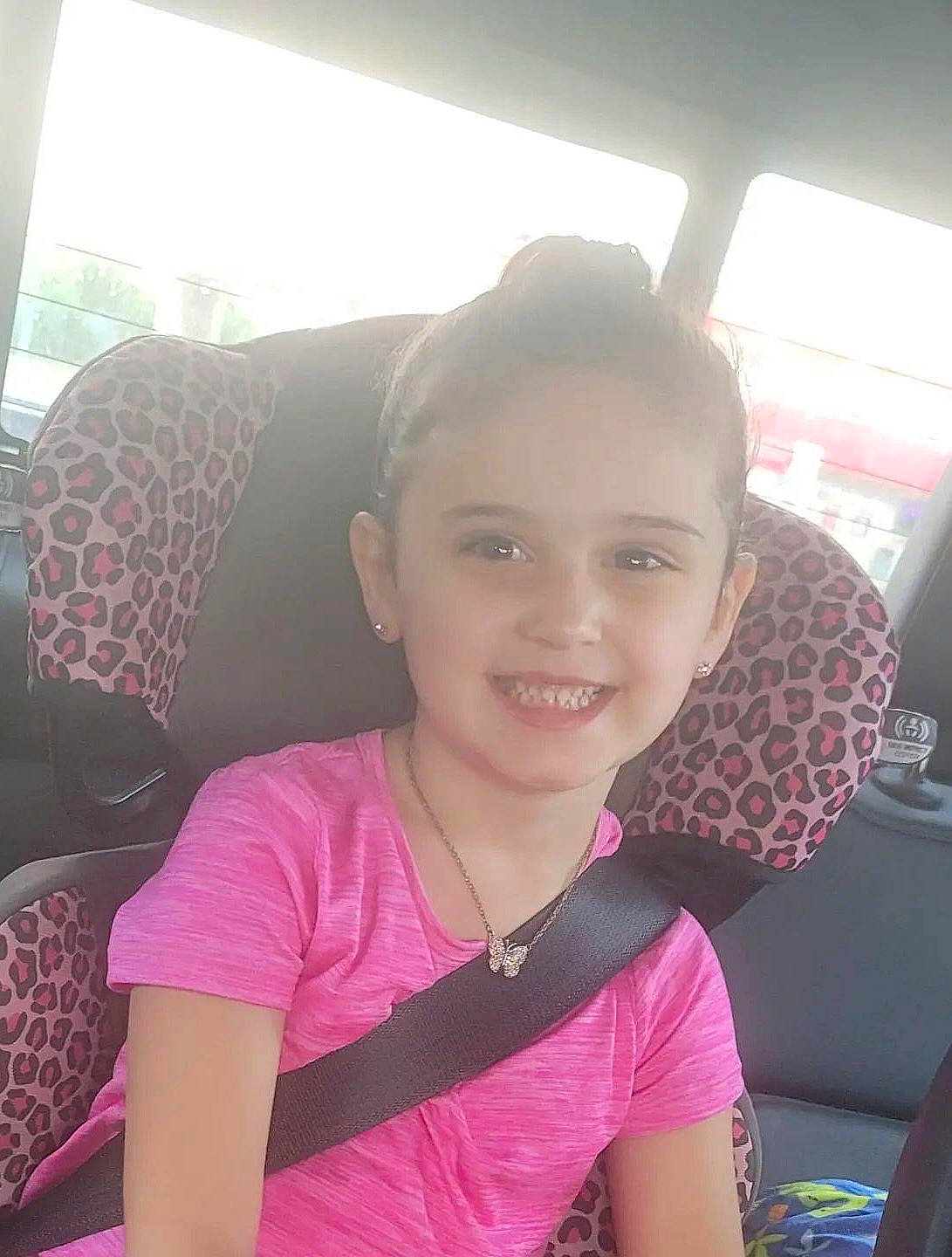 Elizabeth is registered to the contest to win money with this photo: black_hair, child, chin, comfort, cool, eyebrow, happy, iris, joy, leisure, lip, long_hair, magenta, neck, nose, person, pink, skin, smile, t_shirt