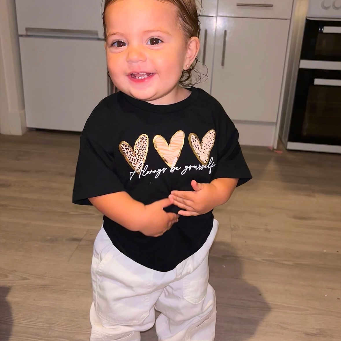 Olive is registered to the contest to win money with this photo: bodypart, boy, child, clothing, face, happy, head, indoors, interiordesign, male, mouth, pants, person, photography, portrait, shirt, sleeve, smile, t_shirt, teeth