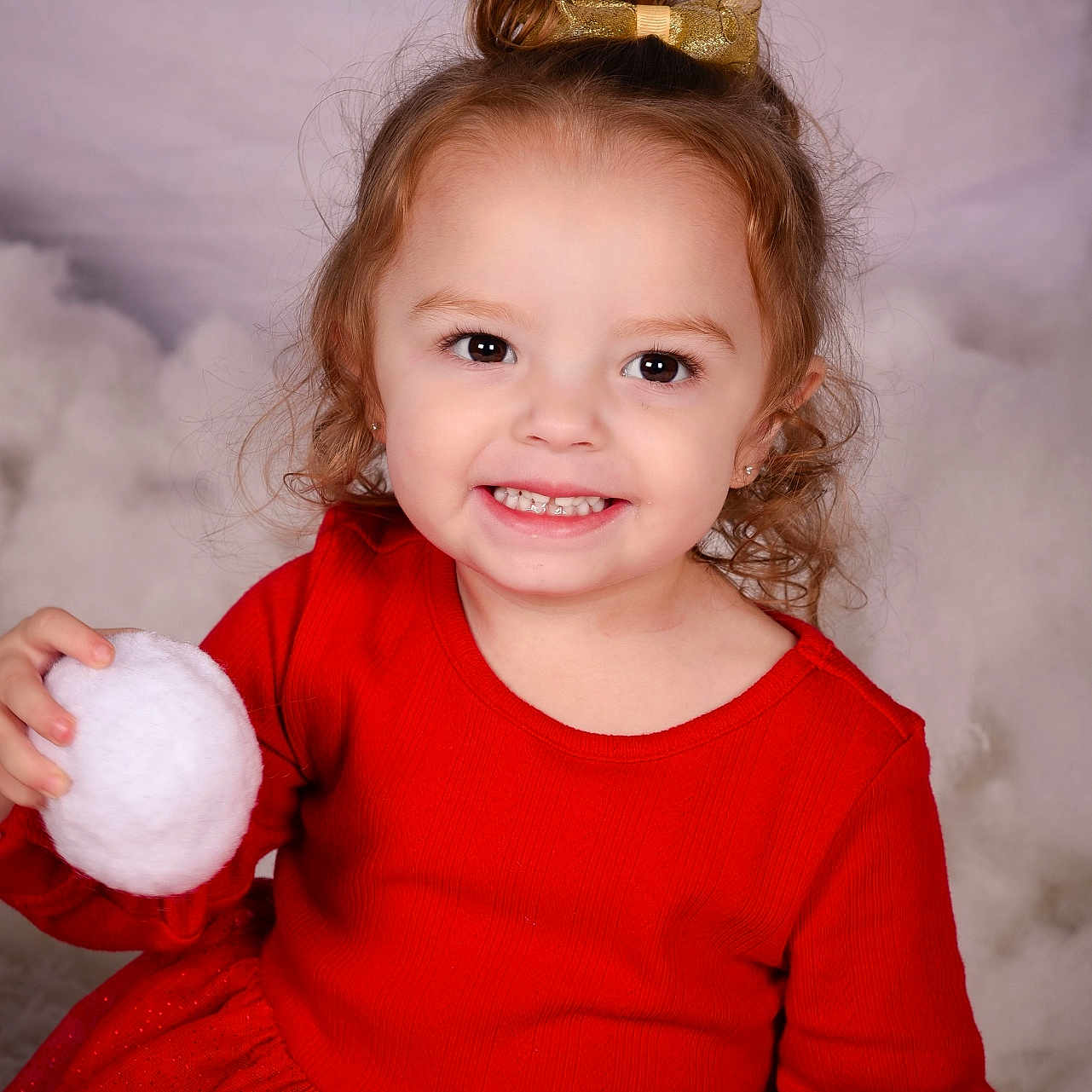 Delilah is registered to the contest to win money with this photo: bodypart, child, clothing, dress, face, female, finger, food, girl, hand, happy, head, nature, outdoors, person, photography, portrait, smile, snow, sweets