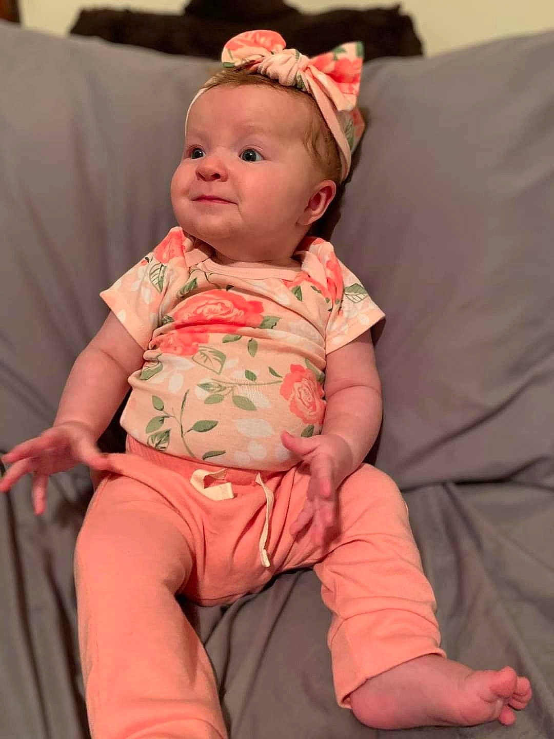 Lorraina is registered to the contest to win money with this photo: arm, baby, baby_toddler_clothing, cheek, child, comfort, elbow, face, finger, hand, happy, head, knee, person, pink, sitting, skin, sleeve, thigh, toddler