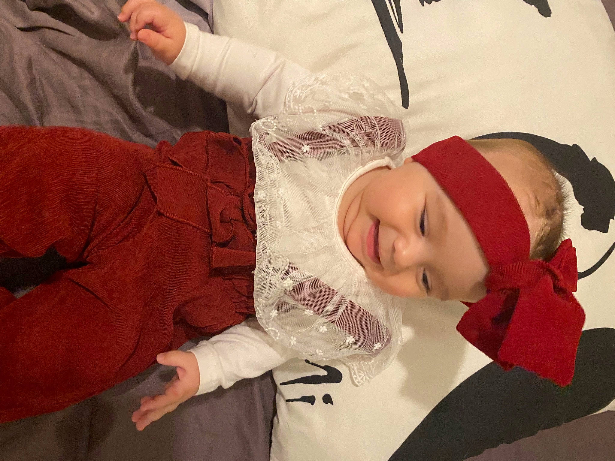 Maddy a rejoint le concours — aidez-le/la à gagner de superbes lots ! baby, baby_toddler_clothing, carmine, child, comfort, dress, event, fictional_character, fun, gesture, hand, happy, hat, headwear, person, room, sitting, smile, toddler, tradition