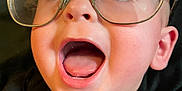 Felix joined the competition — help win amazing prizes! baby, child, face, glasses, red_glasses, open_mouth, blue_eyes, black_shirt, closeup, expression, happy, curious, human, portrait, head, skin, eyewear, infant, cute, looking_up