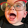 baby, child, face, glasses, red_glasses, open_mouth, blue_eyes, black_shirt, closeup, expression, happy, curious, human, portrait, head, skin, eyewear, infant, cute, looking_up