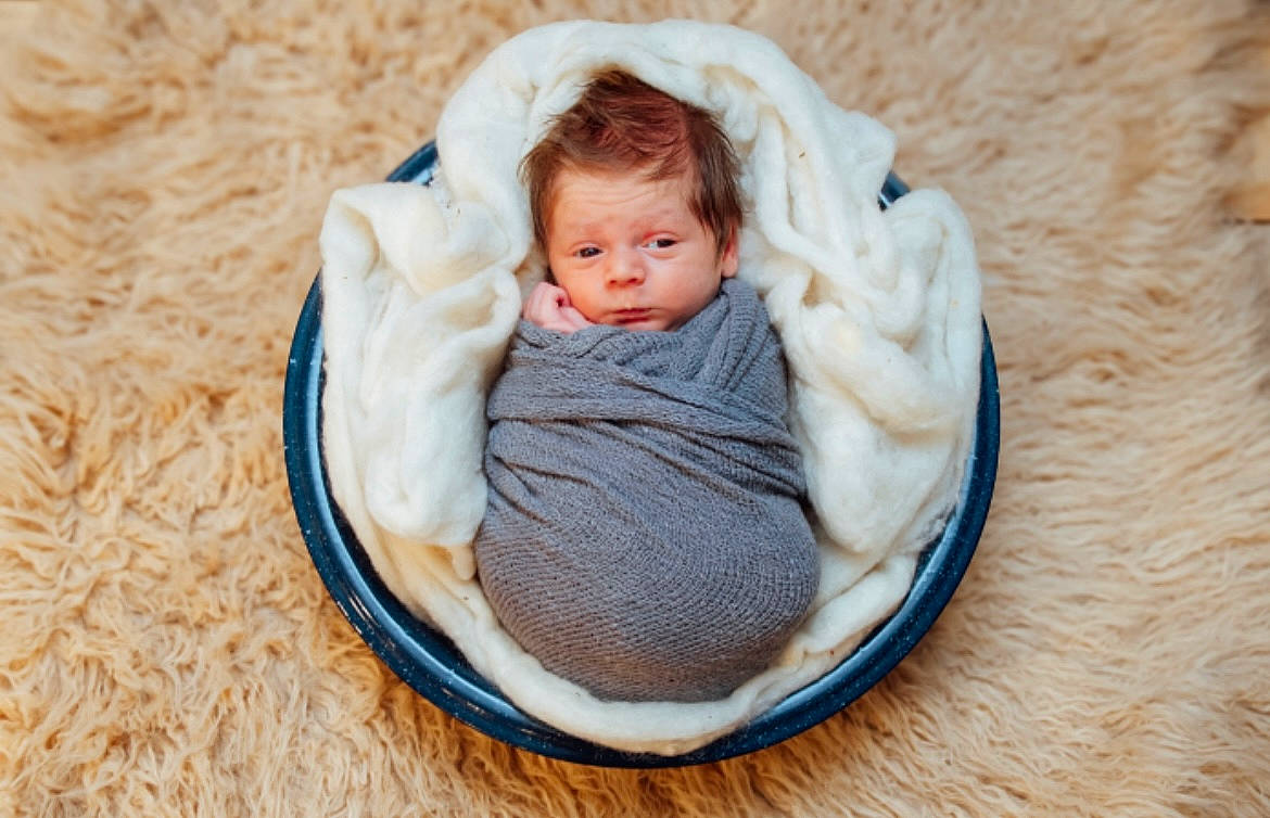 Kohen is registered to the contest to win money with this photo: baby, baby_products, baby_sleeping, baby_toddler_clothing, basket, child, comfort, event, fashion_accessory, grass, infant_bed, linens, person, portrait_photography, sitting, textile, thread, toddler, wood, wool
