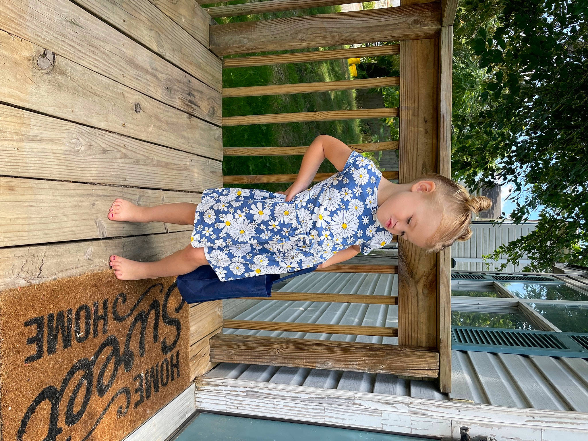 Everleigh is registered to the contest to win money with this photo: child, composite_material, electric_blue, fun, happy, hardwood, human_leg, leg, leisure, pattern, people_in_nature, person, sitting, symmetry, thigh, toddler, tree, vacation, wood, wood_stain