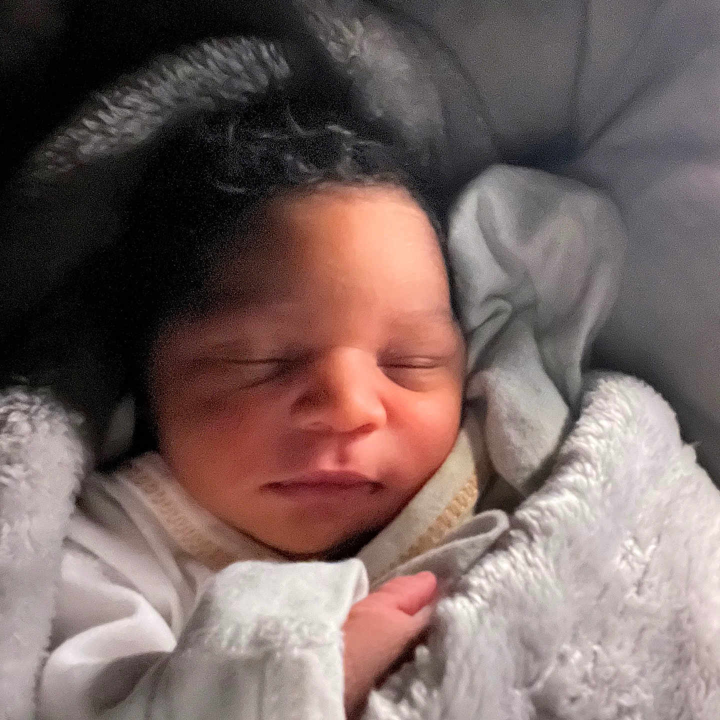 Azaiah joined the competition — help win amazing prizes! baby, blanket, child, closeup, clothing, cozy, curly_hair, cute, face, indoors, infant, newborn, peaceful, portrait, resting, sleeping, soft, tiny_hand, warm_light, wrapped