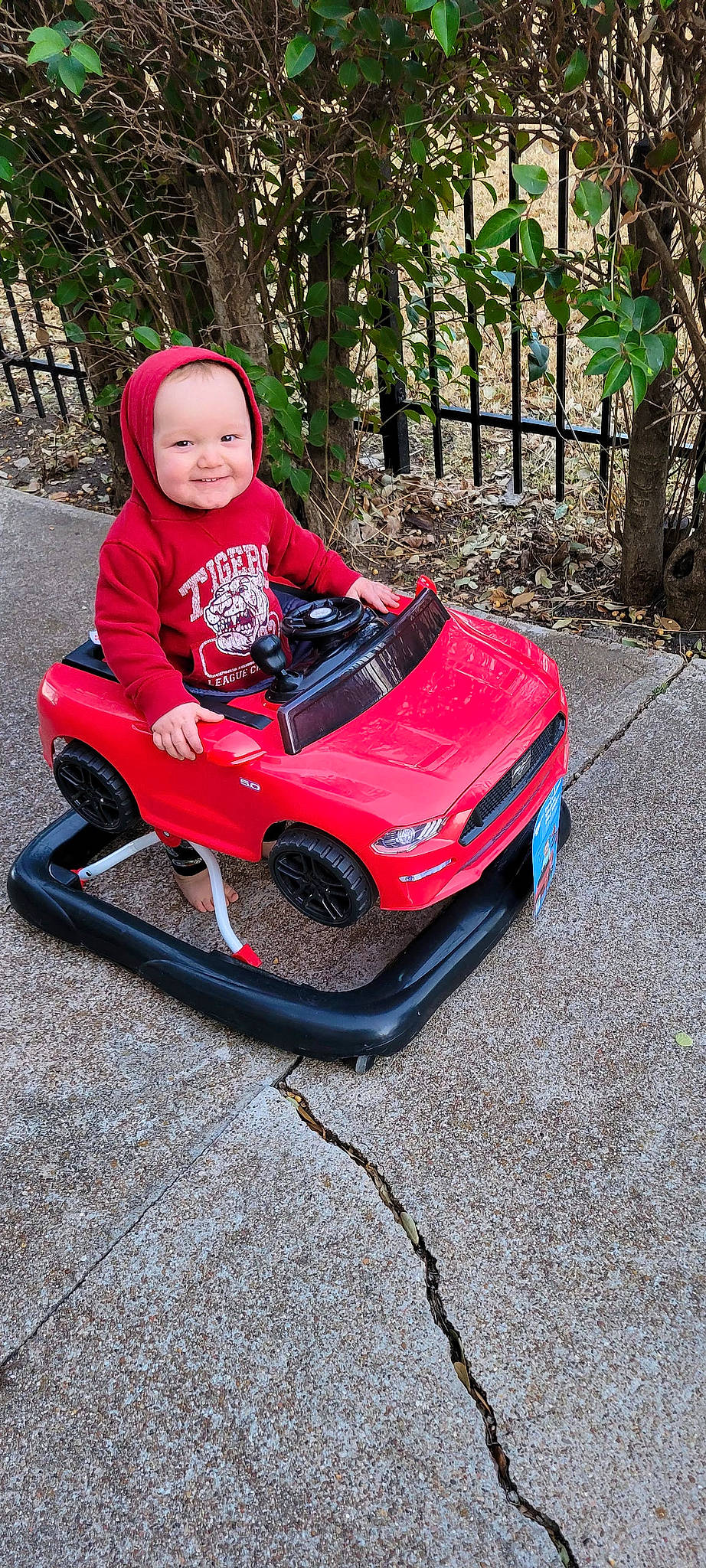 Leelynn is registered to the contest to win money with this photo: automotive_exterior, automotive_lighting, baby, baby_toddler_clothing, bumper, carmine, comfort, grass, helmet, hood, joy, leisure, motor_vehicle, person, plant, recreation, sitting, smile, tire, toddler