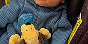 Riley is registered to the contest to win money with this photo: baby, blue_clothing, car_seat, child, cute, face, indoor, infant, knitwear, mittens, pacifier, person, plush_toy, portrait, seatbelt, smile, soft_toy, striped, warm_clothing, warning_label