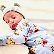 Mustafa joined the competition — help win amazing prizes! baby, newborn, sleeping, onesie, hat, bear_ears, pillow, sleep, cute, infant, child, bed, blanket, soft, cozy, indoors, clothing, peaceful, rest, portrait