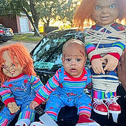 Dshawn joined the competition — help win amazing prizes! baby, child, doll, chucky, costume, halloween, toy, knife, fake_blood, outdoor, car, red_hair, blue_overalls, stripes, face_paint, scary, tied_up, hand, shoes, person