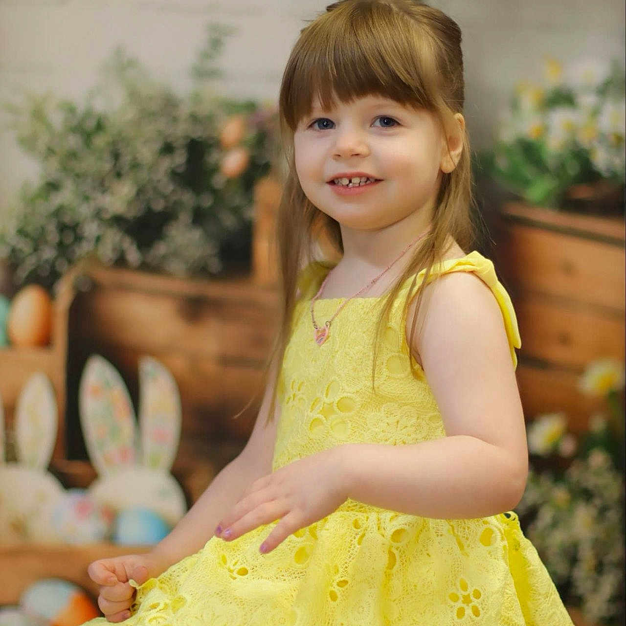 Mirranda joined the competition — help win amazing prizes! background, bunny_ears, child, colorful, cute, decor, easter, festive, flower, girl, happy, holiday, indoor, long_hair, necklace, portrait, sitting, smile, spring, yellow_dress