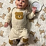 Elohim is registered to the contest to win money with this photo: baby, bear_pattern, blanket, child, clothing, cozy, cute, face, happy, head, indoors, infant, lying_down, pajamas, person, smiling, socks, soft, toddler, young_child