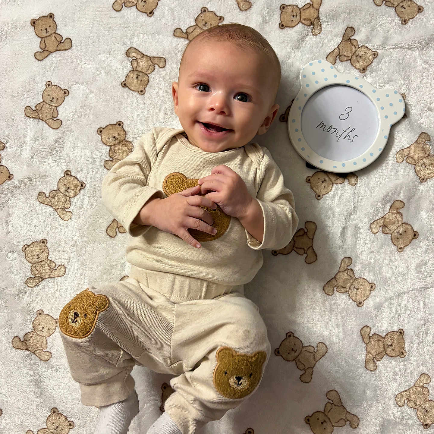 Elohim is registered to the contest to win money with this photo: age_marker, baby, bear_patch, blanket, child, clothing, cozy, cute, frame, happy, indoors, infant, lying_down, playful, portrait, smiling, soft_texture, teddy_bear_pattern, white_socks, young_child