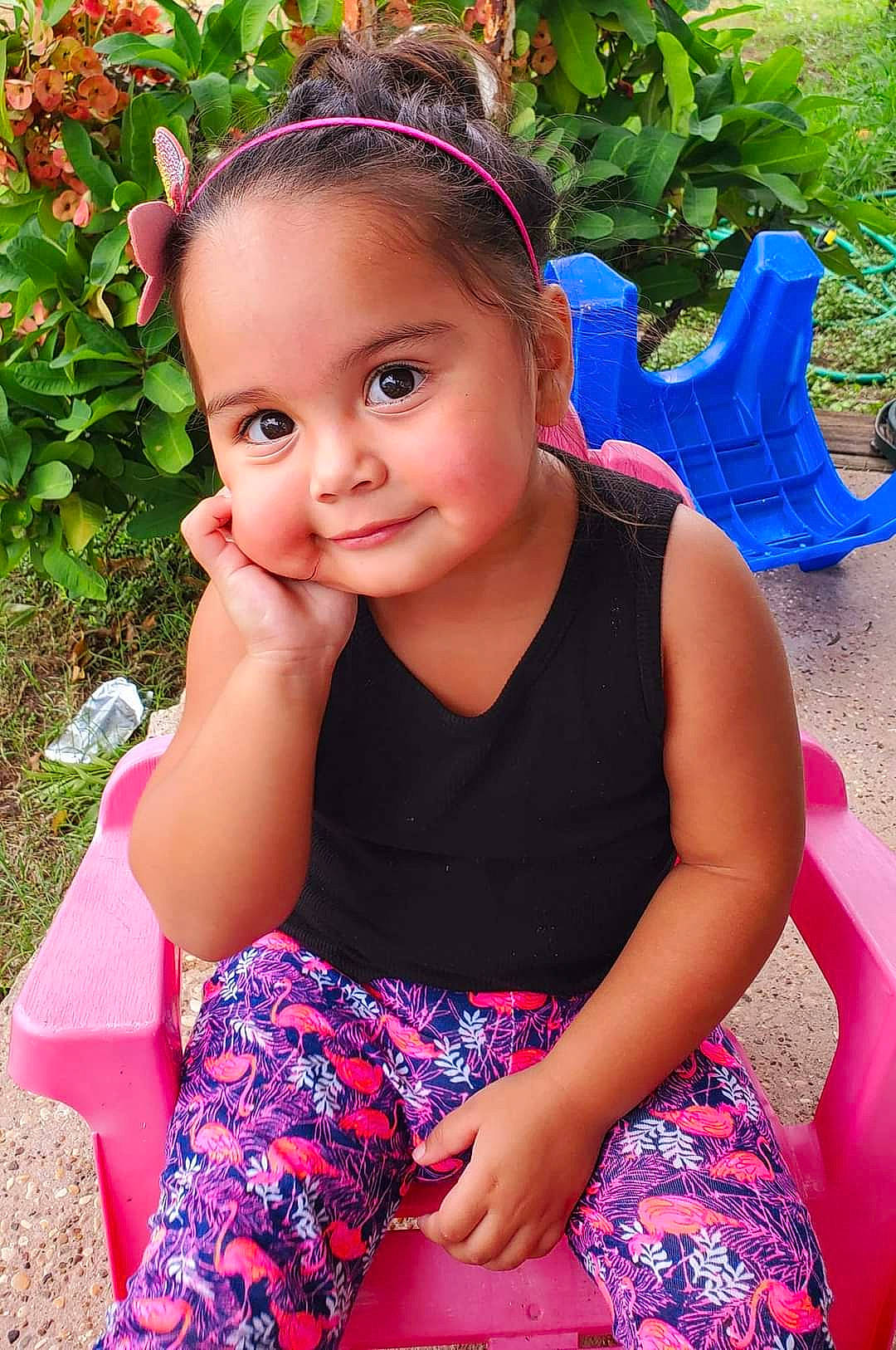 Carly is registered to the contest to win money with this photo: child, child_model, fashion_accessory, hair_accessory, headband, person, pink, sitting, smile, summer, toddler, vacation