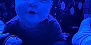 Bobbie joined the competition — help win amazing prizes! baby, infant, hand_holding, blue_light, holiday_lights, christmas_tree, festive, cute, face, expression, indoor, child, person, closeup, smile, candid, warm_clothing, background_blur, interaction, joy