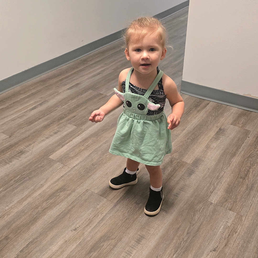 Lane is registered to the contest to win money with this photo: bodypart, clothing, dress, face, finger, footwear, hand, hardwood, head, indoors, interiordesign, pants, person, photography, plywood, portrait, sandal, shoe, shorts, wood