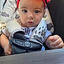 baby, child, infant, headband, red_flower, car_seat, harness, seatbelt, closeup, face, eyes, hands, clothing, patterned, sitting, portrait, cute, indoors, person, young