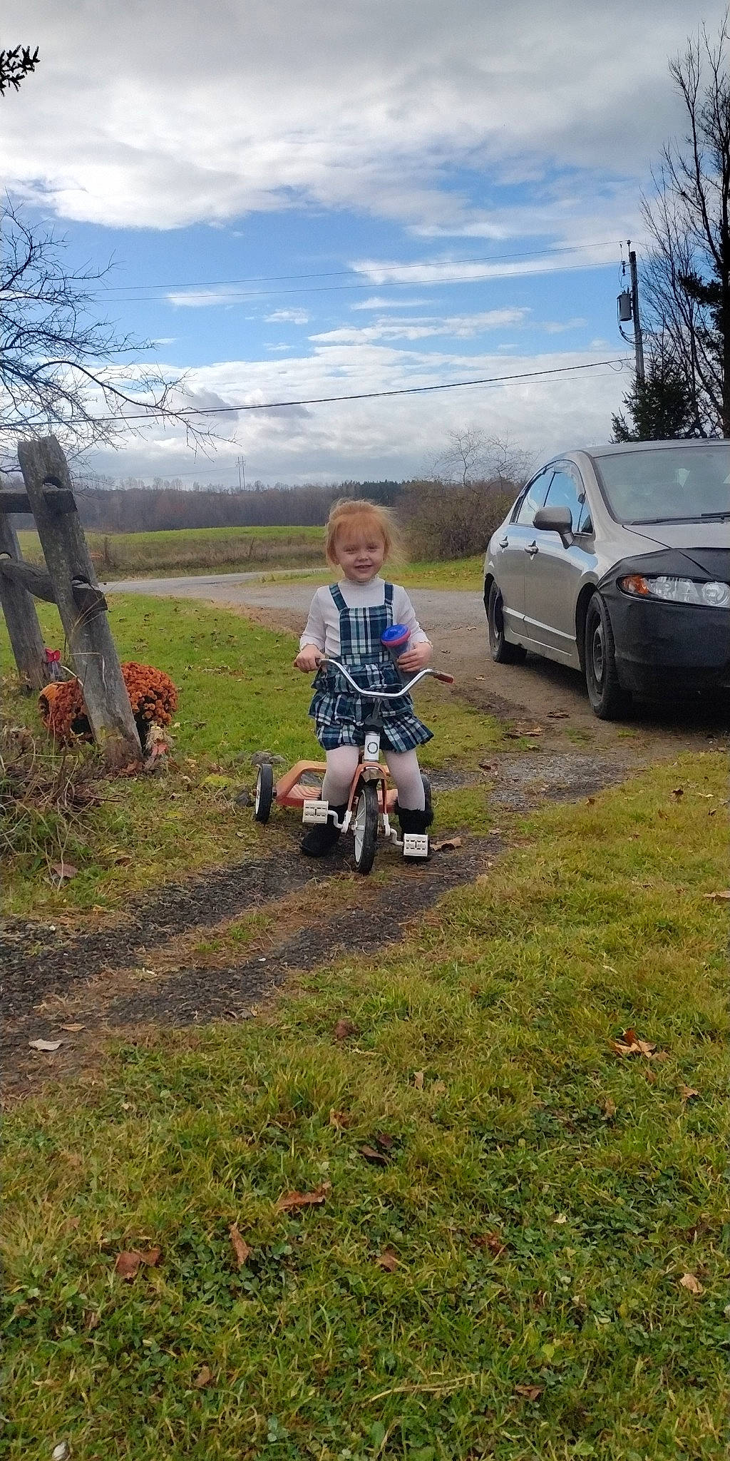 Skyler joined the competition — help win amazing prizes! asphalt, automotive_tire, car, cloud, grass, grassland, jacket, joy, land_vehicle, landscape, motor_vehicle, person, plant, rolling, sky, smile, tire, toddler, tree, vehicle