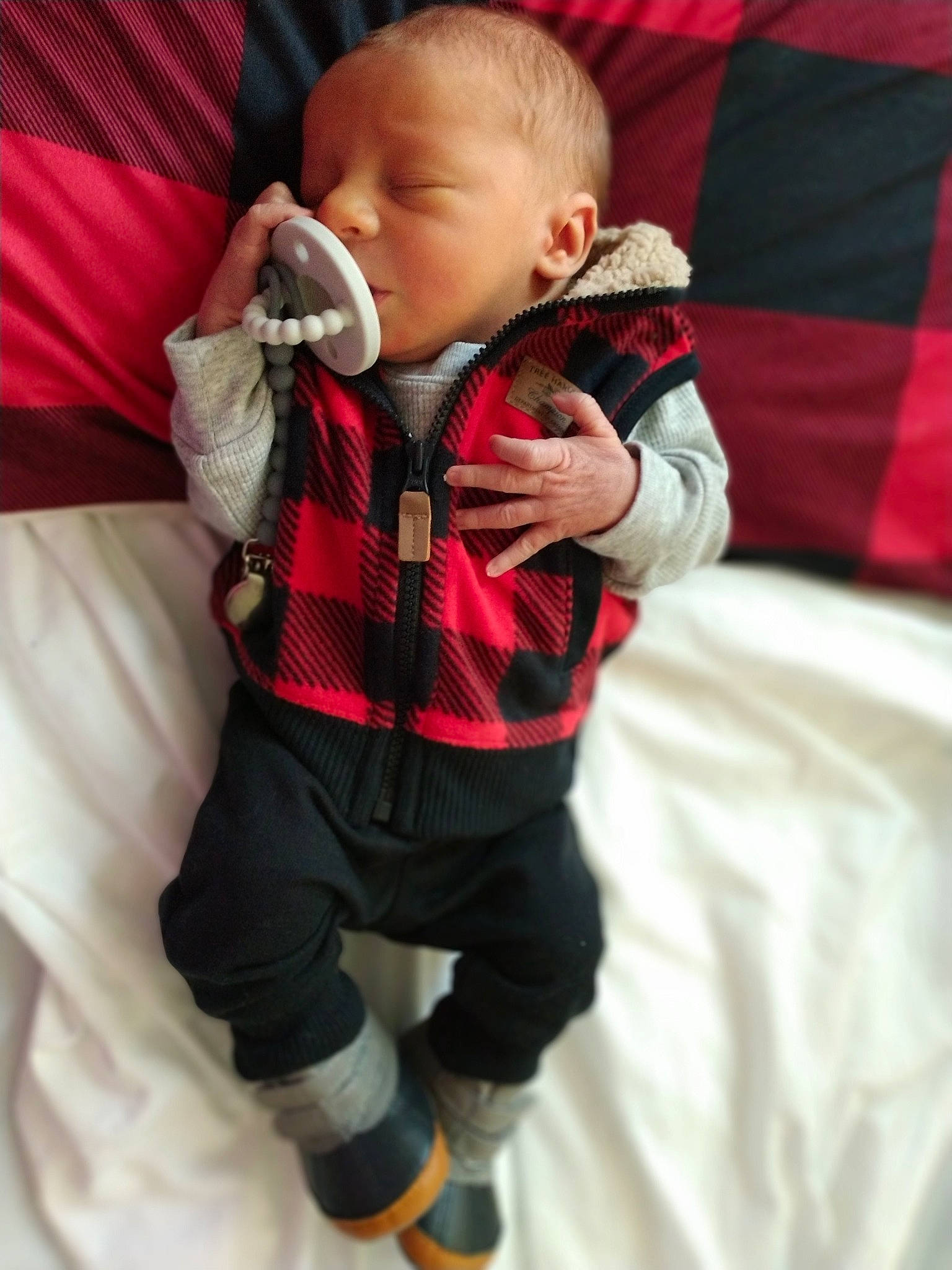 Cason is registered to the contest to win money with this photo: baby, baby_toddler_clothing, cheek, child, comfort, event, eye, finger, fun, gesture, happy, head, human_body, pattern, person, personal_protective_equipment, plaid, sleeve, standing, textile