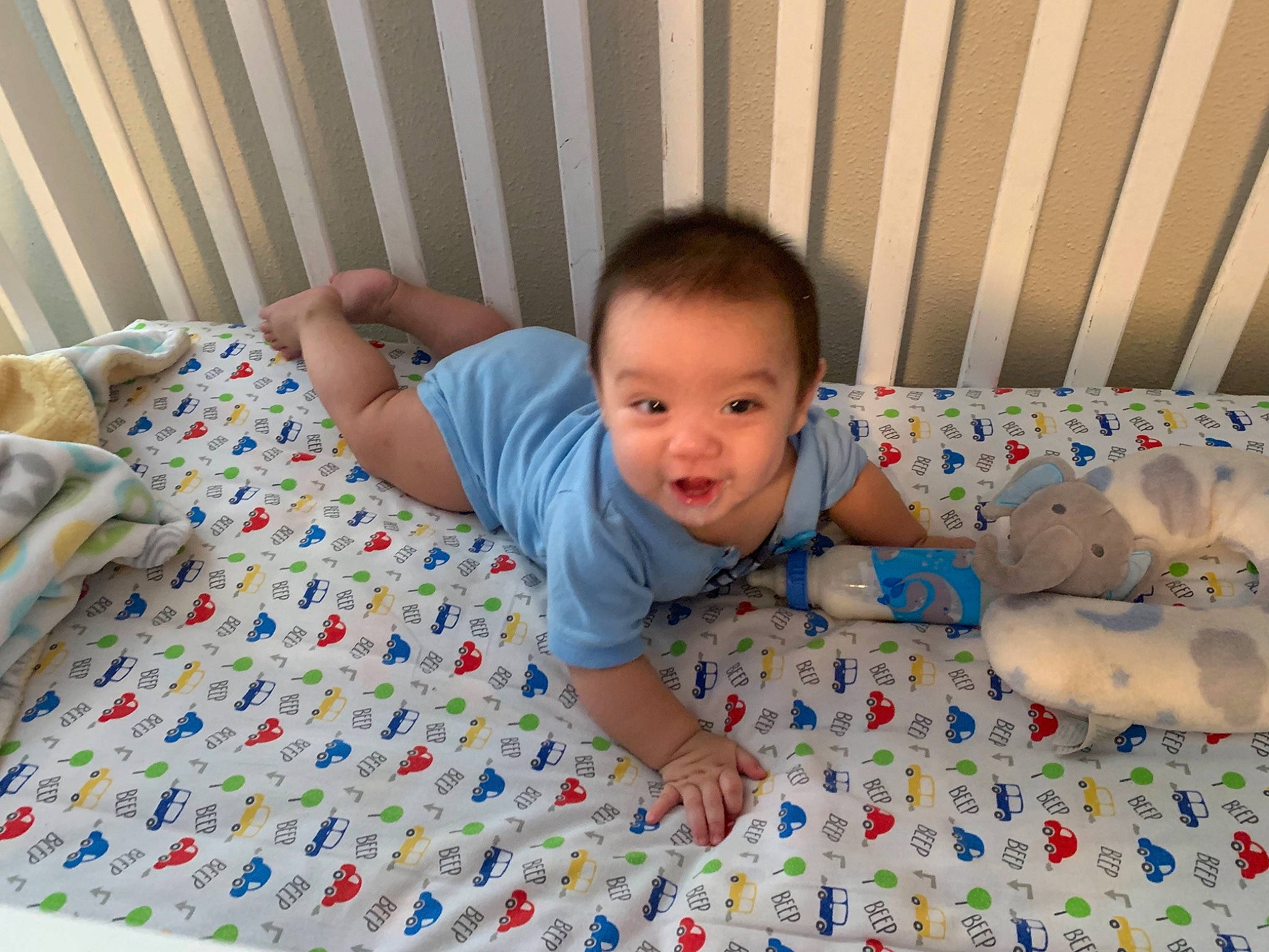 Noah is registered to the contest to win money with this photo: baby, baby_toddler_clothing, bedding, child, comfort, crawling, eye, face, flooring, linens, pattern, person, product, sitting, skin, sleeve, smile, t_shirt, textile, toddler