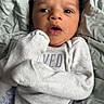 baby, newborn, infant, clothing, blanket, bed, face, person, cute, expression, sleepwear, cozy, small, child, portrait, indoors, soft, lying_down, wrapped, young