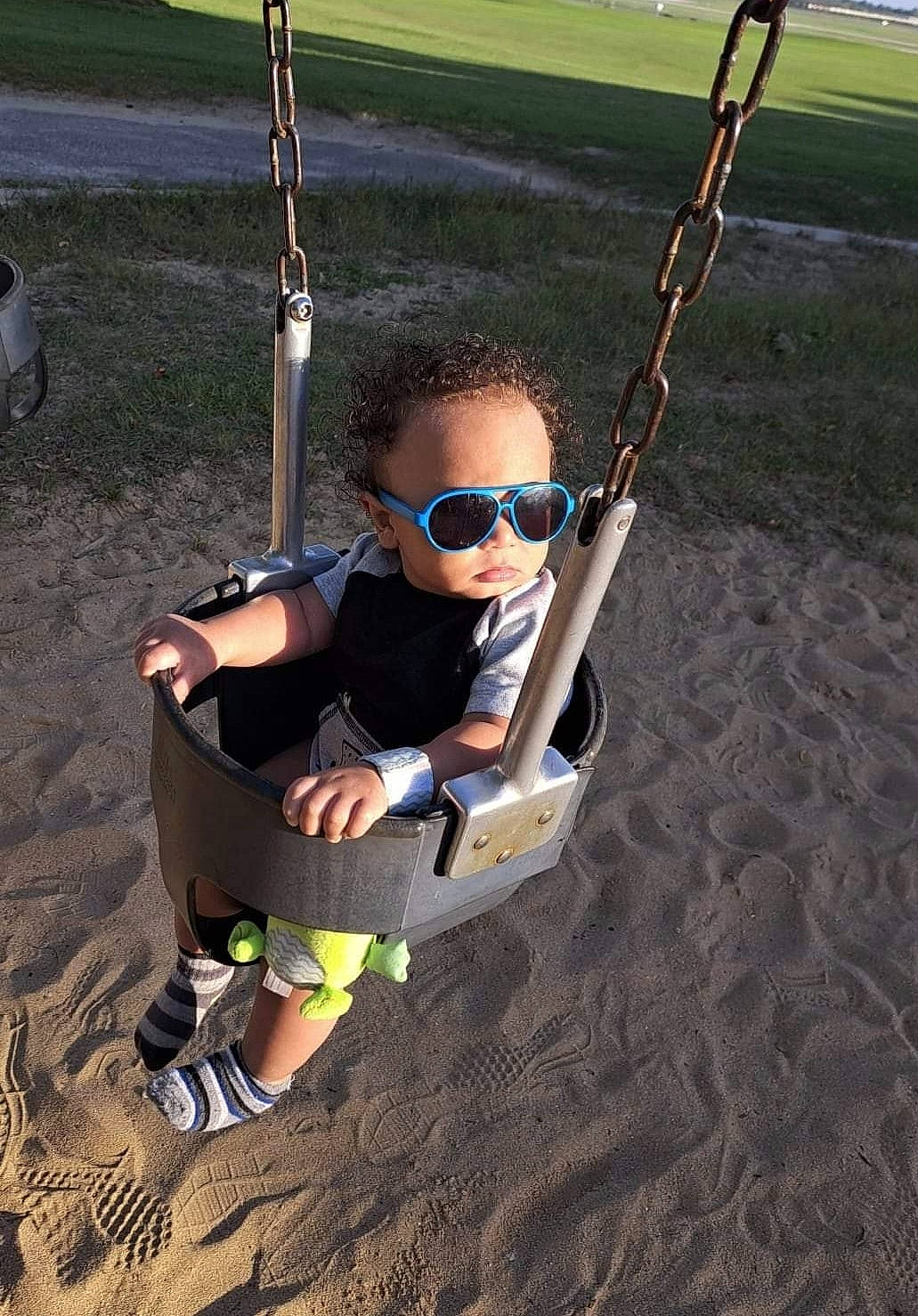 Cartier joined the competition — help win amazing prizes! baby, baby_toddler_clothing, child, city, electric_blue, eyewear, fun, grass, leisure, outdoor_play_equipment, person, play, playground, recreation, sandal, shadow, sitting, swing, thigh, toddler