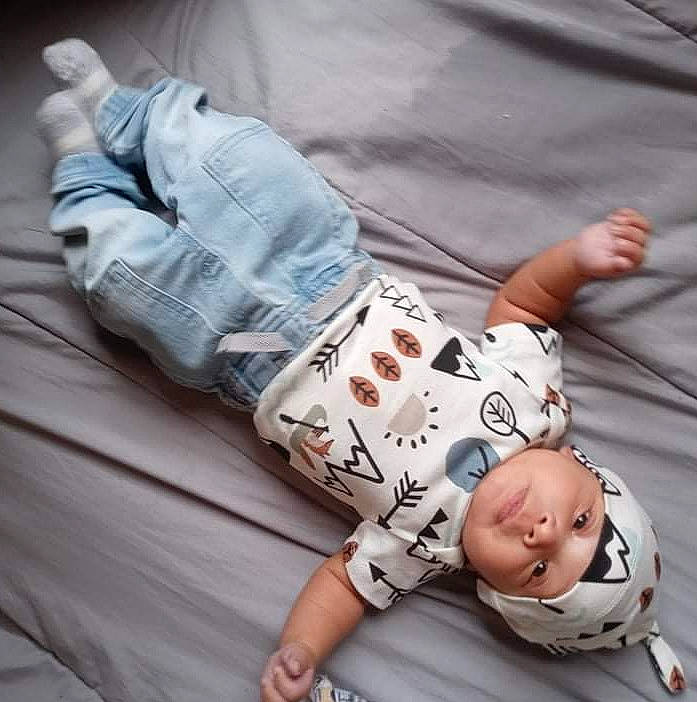 Cartier is registered to the contest to win money with this photo: baby, baby_sleeping, baby_toddler_clothing, child, comfort, cool, elbow, finger, gesture, hand, happy, headwear, human_leg, joint, knee, person, product, sleeve, t_shirt, textile
