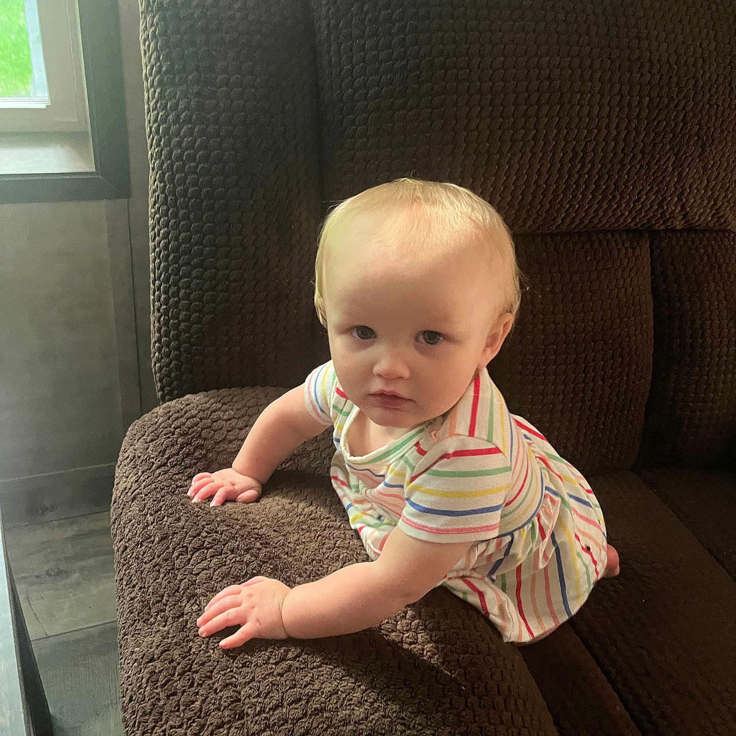 Emberly joined the competition — help win amazing prizes! baby, child, couch, furniture, indoor, window, light, texture, striped_clothing, serious_expression, crawling, person, home, floor, seat, armrest, blond_hair, young_child, infant, casual