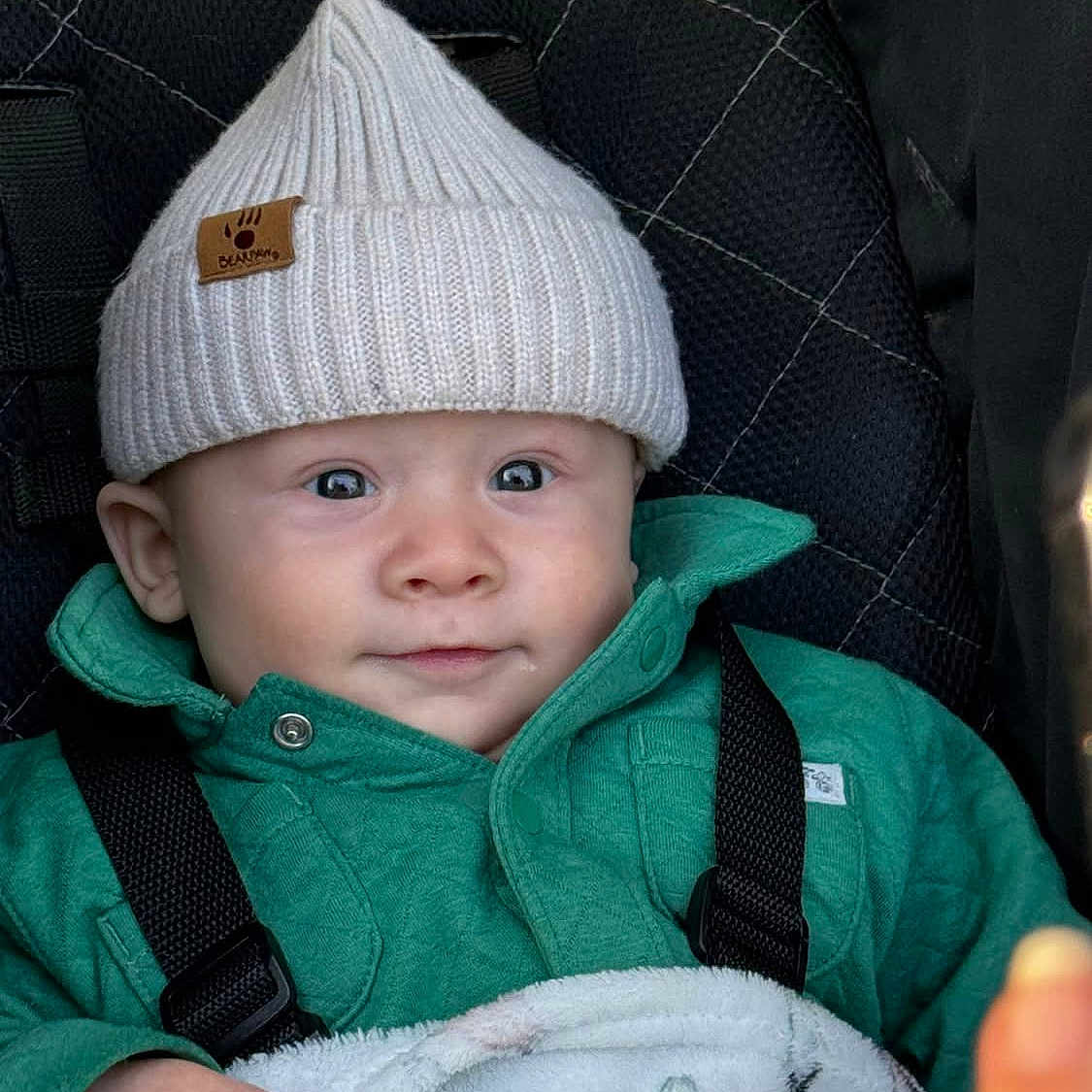 Liam joined the competition — help win amazing prizes! baby, beanie, bodypart, bonnet, cap, clothing, coat, face, finger, hand, happy, hat, head, hood, jacket, pants, person, photography, portrait, smile
