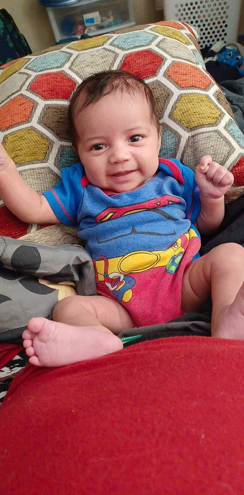 Mae is registered to the contest to win money with this photo: baby, baby_carriage, baby_toddler_clothing, chair, cheek, child, comfort, eye, fun, hand, happy, human_body, lap, leg, leisure, mouth, person, skin, smile, thigh