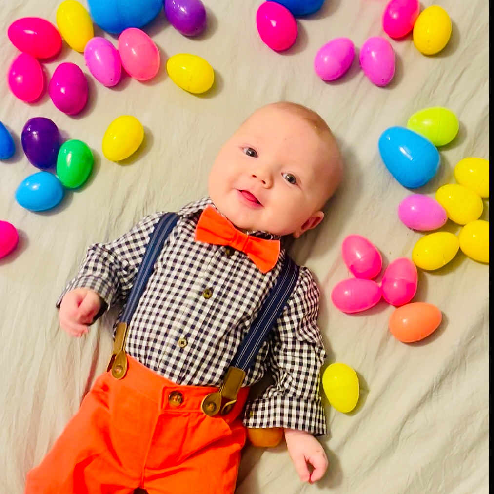 Coleson is registered to the contest to win money with this photo: accessories, baby, balloon, candy, clothing, face, food, formalwear, head, jewelry, necklace, pants, people, person, photography, portrait, purple, sweets, tie, toy