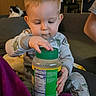 Jayce is registered to the contest to win money with this photo: toddler, child, baby, pajamas, jar, seasoning, couch, cat, pet, indoor, home, furniture, curious, sitting, hand, face, person, clothing, living_room, cozy