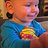 Jayce joined the competition — help win amazing prizes! toddler, child, smile, blue_shirt, cookie_jar_print, indoor, closeup, happy, curious, face, cheeks, person, baby, long_sleeve, couch, furniture, warm_lighting, young_child, cute, portrait