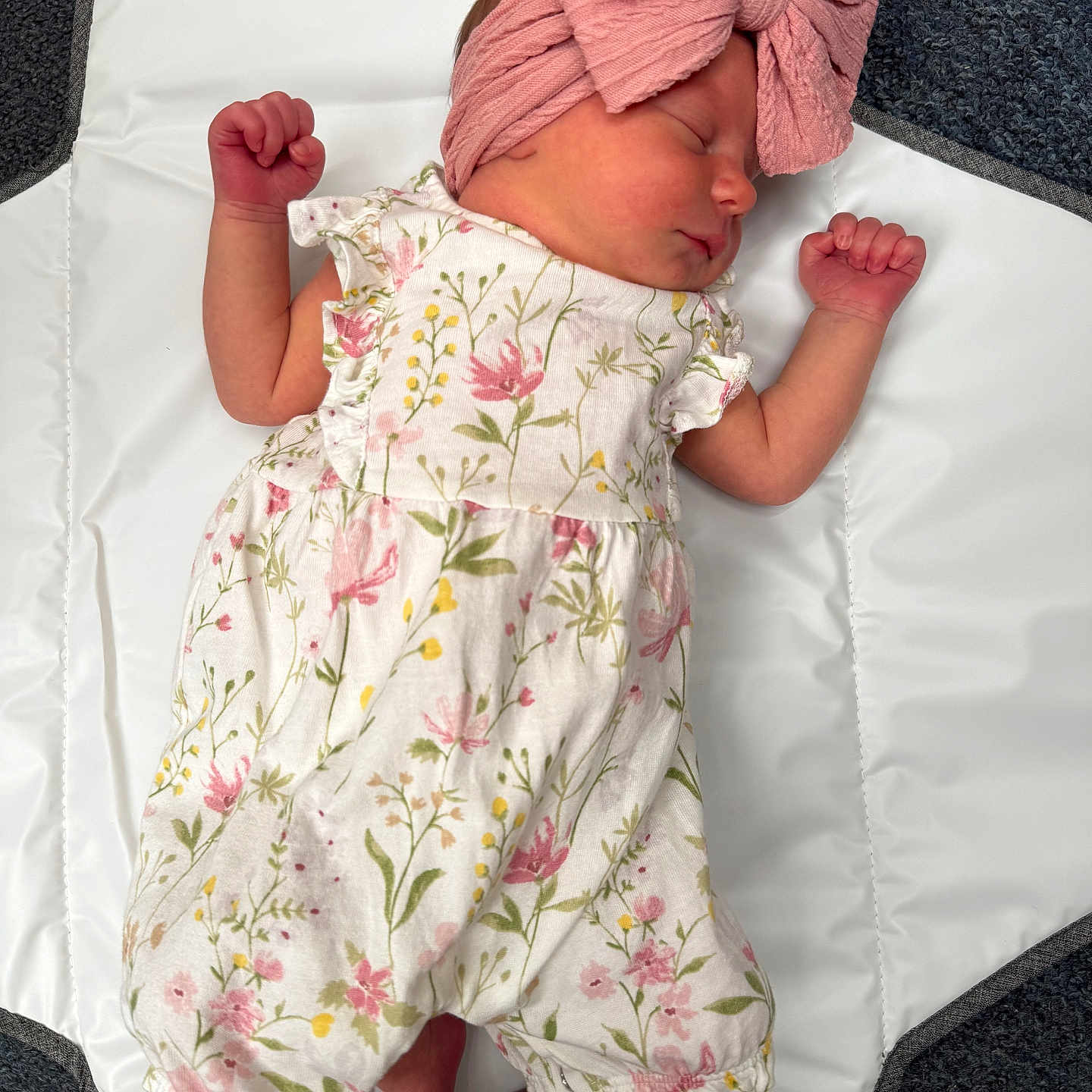 Delilah-Rose joined the competition — help win amazing prizes! baby, baby_girl, carpet, child, closeup, clothing, cute, floral_romper, headband, indoors, infant, newborn, peaceful, pink_bow, portrait, resting, sleeping, soft_lighting, tiny_fists, white_mat
