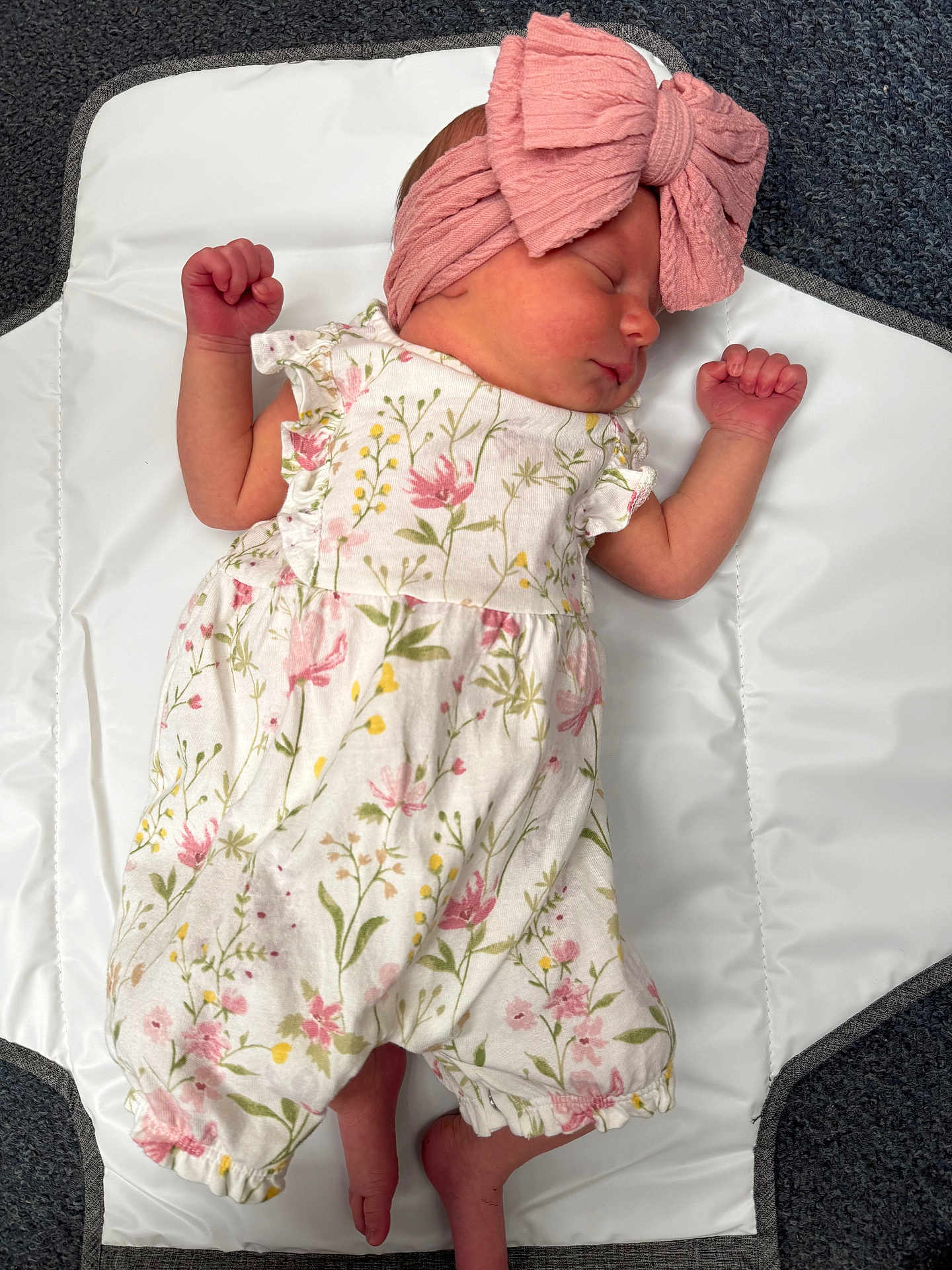 Delilah-Rose joined the competition — help win amazing prizes! newborn, baby, sleeping, infant, headband, pink_bow, floral_romper, white_mat, carpet, cute, peaceful, tiny_fists, portrait, indoors, soft_lighting, child, resting, clothing, baby_girl, closeup