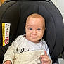 Elyo participe au concours pour gagner de l'argent avec cette photo : baby, child, car_seat, blanket, blue_eyes, smile, infant, clothing, hand, face, indoor, kitchen, cabinet, food_package, cute, comfort, seated, white_shirt, expression, young_child