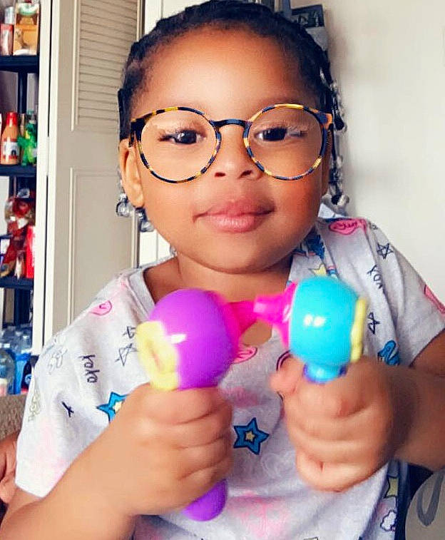 Nyla T is registered to the contest to win money with this photo: balloon, child, eyewear, glasses, happy, joy, party_supply, person, smile, toddler, toy, vision_care