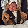 baby, infant, car_seat, blanket, fur_costume, hooded_outfit, child, cute, face, portrait, indoors, seatbelt, soft_toys, warm, newborn, clothing, cozy, expression, headwear, small