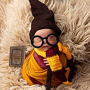 Grayson is registered to the contest to win money with this photo: baby, sleeping, costume, wizard, hat, glasses, scarf, blanket, knitted, book, spellbook, cute, portrait, infant, wrapped, soft, cozy, child, fantasy, magic