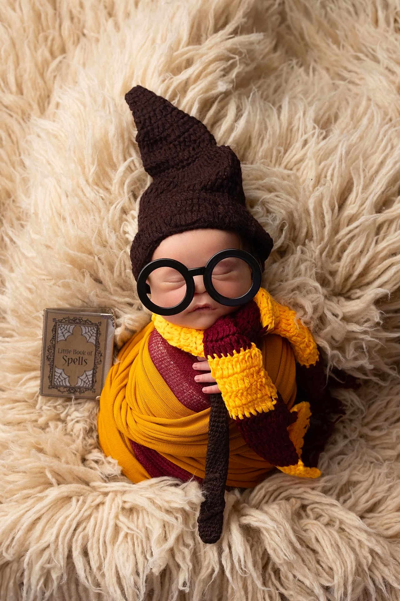Grayson is registered to the contest to win money with this photo: baby, sleeping, costume, wizard, hat, glasses, scarf, blanket, knitted, book, spellbook, cute, portrait, infant, wrapped, soft, cozy, child, fantasy, magic