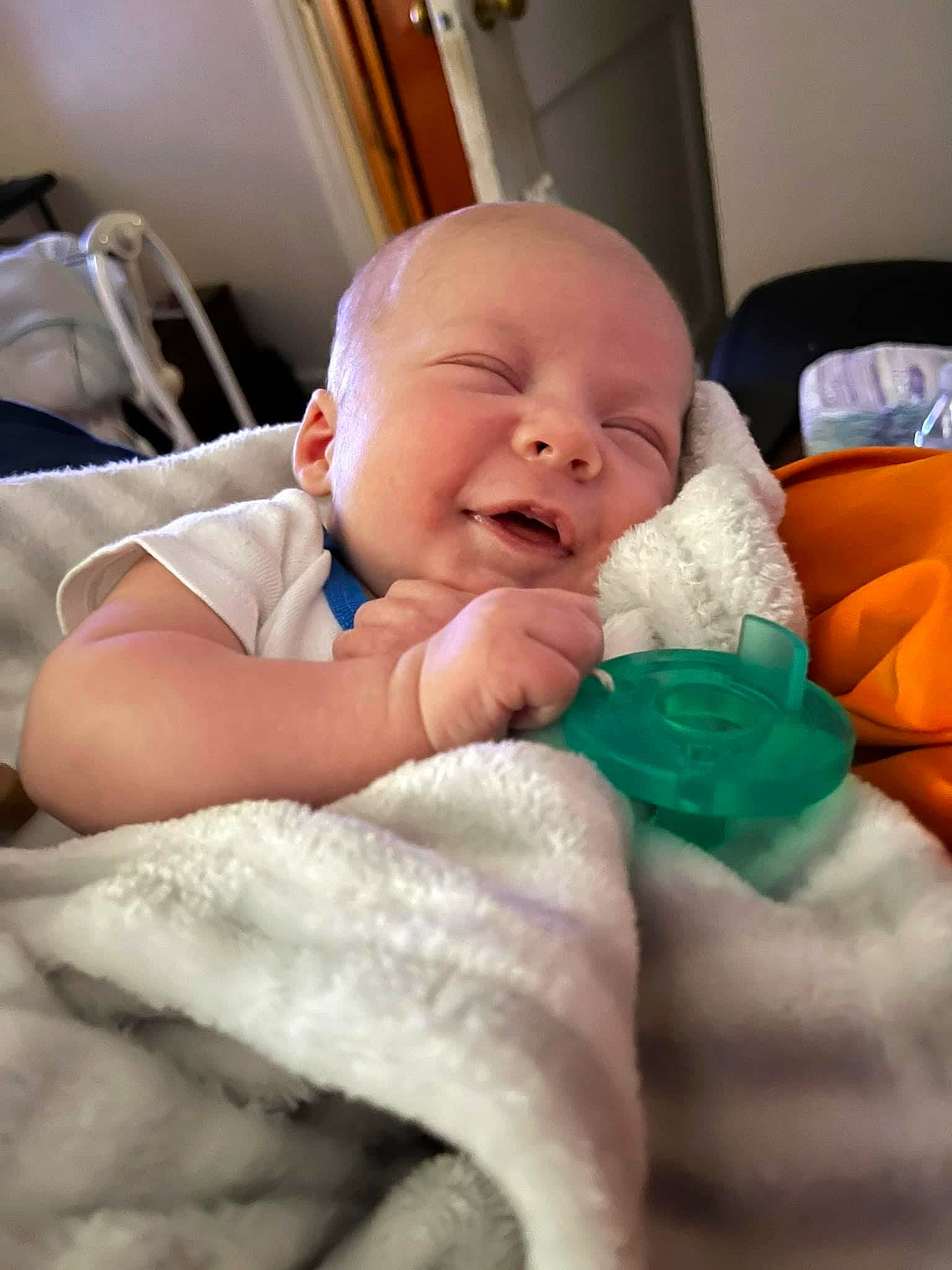 Langston is registered to the contest to win money with this photo: baby, baby_toddler_clothing, birth, cheek, child, comfort, event, finger, fun, happy, iris, laugh, linens, mouth, nose, person, room, skin, smile, thumb