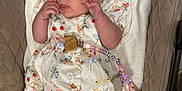 Pebble joined the competition — help win amazing prizes! baby, beads, beige, child, cushion, cute, dress, fabric, floral, headband, indoor, infant, lying_down, pacifier, pattern, person, portrait, quilted, sock, white