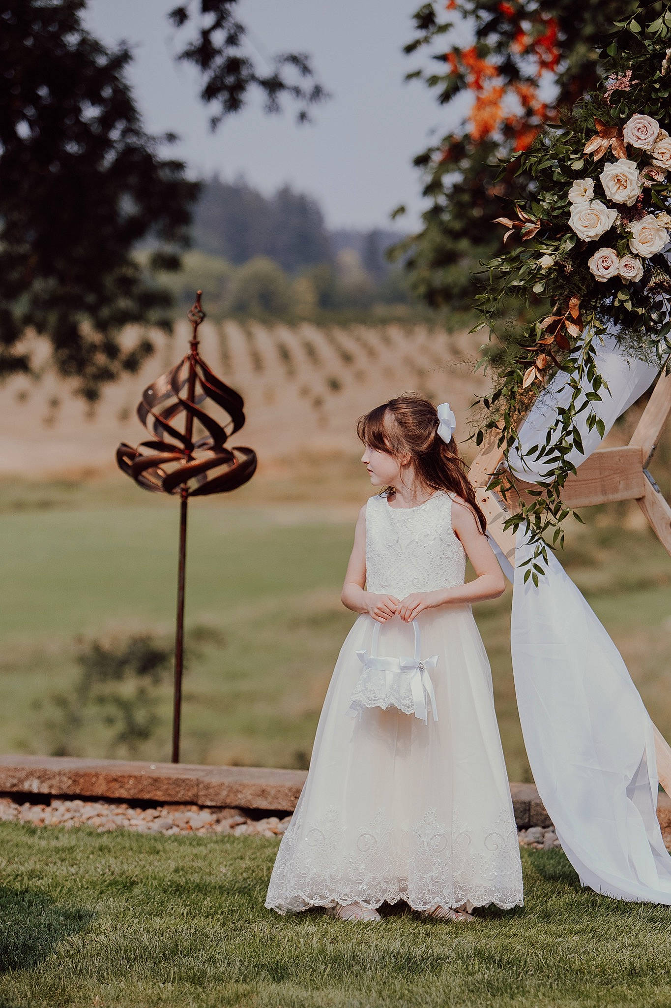 Andi joined the competition — help win amazing prizes! bridal_clothing, bridal_party_dress, bride, clothing, dress, flash_photography, gesture, gown, grass, happy, landscape, nature, people_in_nature, person, petal, plant, shoulder, standing, tree, wedding_ceremony_supply