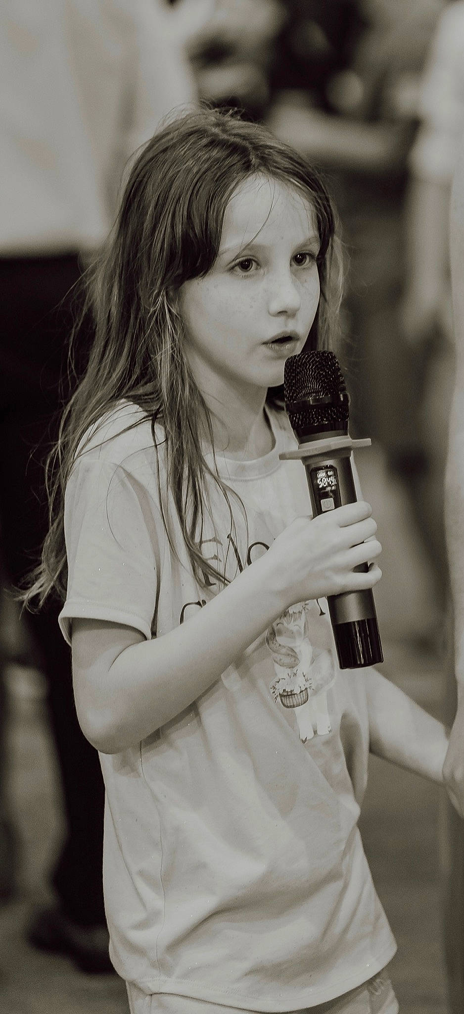 Andi joined the competition — help win amazing prizes! audio_equipment, black_and_white, chin, entertainment, eye, face, flash_photography, gesture, hair, happy, lip, microphone, music, music_artist, musician, organ, person, shirt, singing, street_fashion