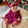 baby, child, infant, purple_dress, headband, christmas_tree, ornaments, blanket, holiday, decorations, floor, indoor, cute, person, sitting, footwear, golden_sandals, tulle_skirt, curious, festive